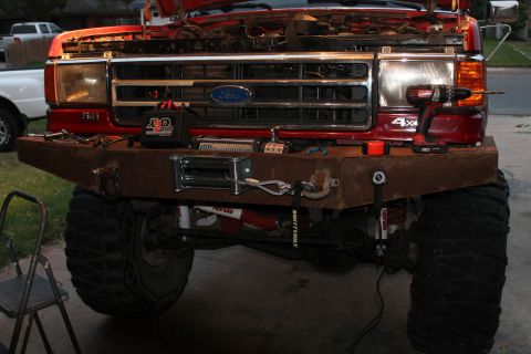 1990 Ford Bronco - Front view of a 1990 Ford Bronco a custom bumper, winch, and a drill on the fender.