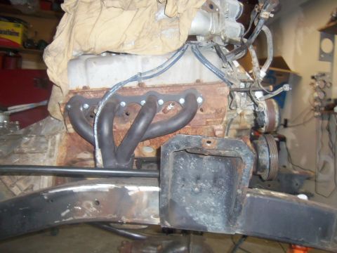 1968 Ford Bronco - Engine block with exhaust headers, part of a vehicle restoration or modification project.