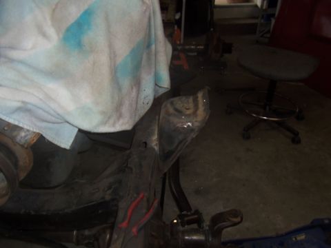 1968 Ford Bronco - Close-up view of the frame and suspension of a 1968 Ford Bronco, with a cloth draped over part of the chassis.