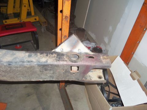 1968 Ford Bronco - A custom metal bracket is bolted to a vehicle's frame, suggesting modifications are underway.