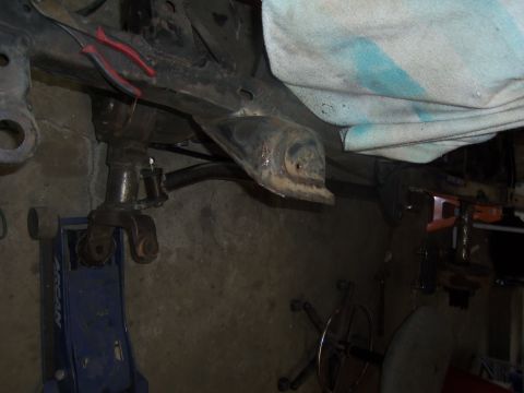 1968 Ford Bronco - Underbody view of a vehicle undergoing maintenance, showing frame and suspension components.