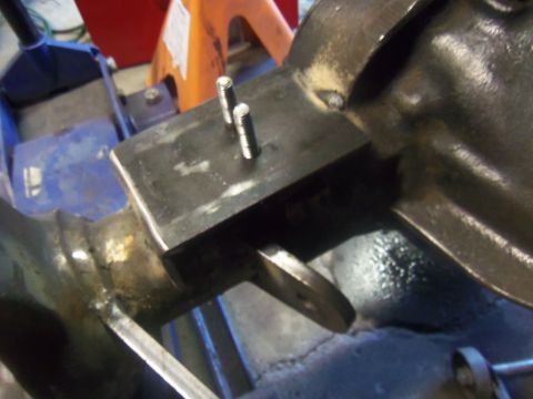 1968 Ford Bronco - Close-up of a modified axle housing a welded bracket and protruding bolts, likely for a vehicle modification project.