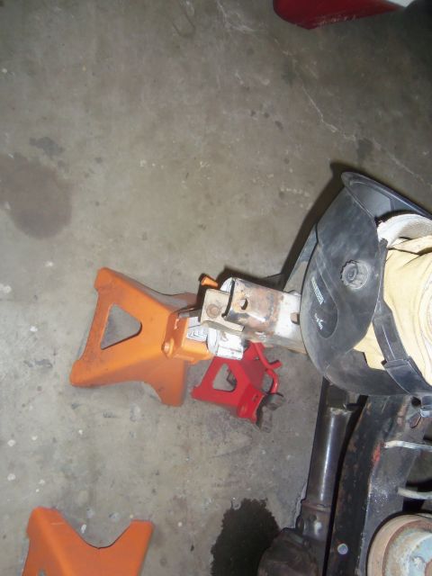 1968 Ford Bronco - Car jacks and a welding mask are visible on a concrete floor, suggesting automotive repair work.