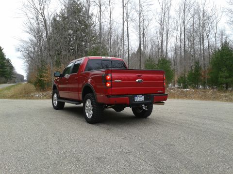 1978 Ford F-150 - Rear view of a red Ford F-150 pickup truck on a road.