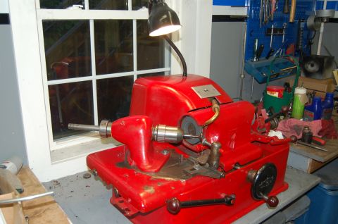 2000 Subaru Forester - A red key cutting machine is set up on a workbench with tools in the background.
