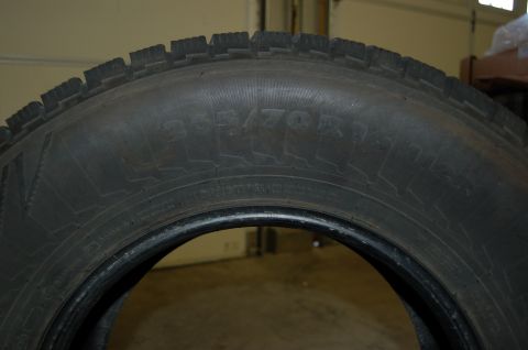 2000 Subaru Forester - A tire with size markings 265/70R18 is shown in a garage setting.
