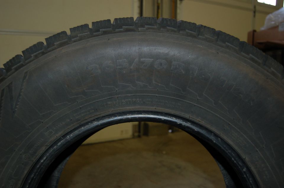 Close-up of a tire with size 265/70R18 printed on it