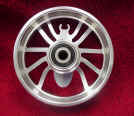 1978 Ford Bronco - Custom aluminum motorcycle wheel with spider-like spokes and a central bearing.