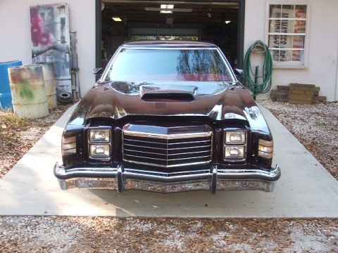 1972 Ford Ranchero - This Ford Ranchero has a prominent grille and dual headlights, with a scoop on the hood.