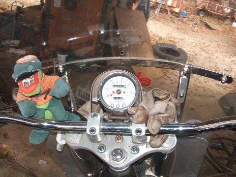 1972 Ford Ranchero - Dashboard of a motorcycle a stuffed toy and a speedometer reading 57715.