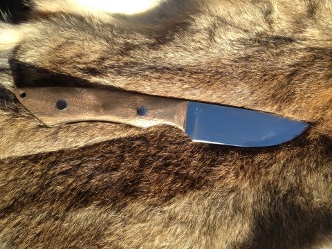 2000 Jeep Wrangler - Knife with wooden handle and shiny blade on fur background.