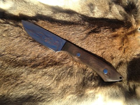 2000 Jeep Wrangler - A knife with a dark wooden handle and a polished metal blade is displayed on a textured, furry background.