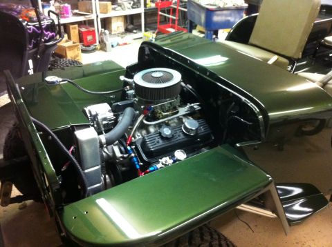 1948 Jeep Wrangler - Jeep CJ-5 engine bay shows a V8 engine with aftermarket parts and an aluminum radiator.