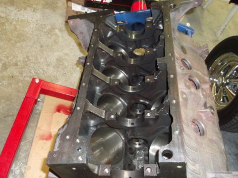 1969 Ford Torino - Close-up view of an engine block, showing the internal structure and bearing mounts. A shiny wheel is visible to the right.