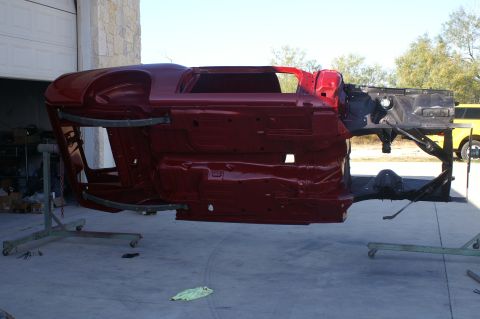 1970 Ford Mustang - The body shell of a 1970 Ford Mustang is shown on a rotisserie, likely undergoing restoration or painting.