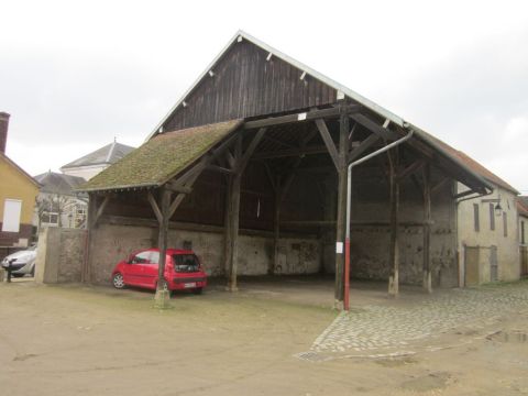 1991 Ford LTD Crown Victoria - Two cars are parked outside a rustic wooden barn on a cloudy day.