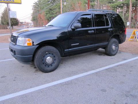1991 Ford LTD Crown Victoria - A black Ford Explorer SUV is parked in a lot, showing its front and side profile.