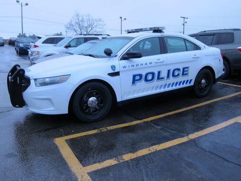 1991 Ford LTD Crown Victoria - A white police car with "WINDHAM POLICE" markings is parked in a lot with other vehicles.