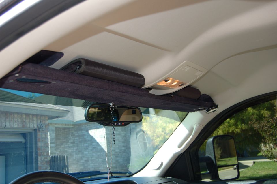 Interior overhead storage compartment with items and rearview mirror