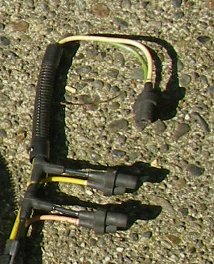 1990 Ford Bronco - Automotive wiring harness with multiple connectors and wires, photographed on a gravel background.
