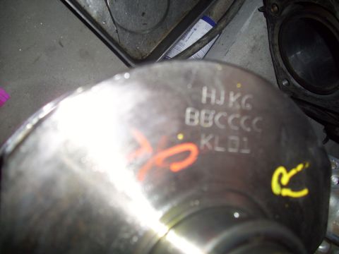 1995 Ford Probe - Close-up of a metal engine component showing stamped alphanumeric codes and painted marks.