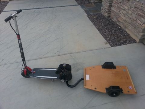 1978 Ford Bronco - A gas-powered scooter is hitched to a small wooden trailer, ready for transport.