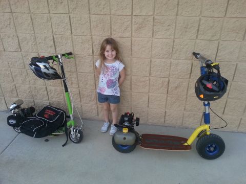 1978 Ford Bronco - A young girl poses with two motorized scooters in front of a textured wall.