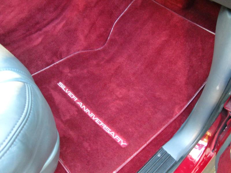 Red carpet floor mat with 'SILVER ANNIVERSARY' text and white piping