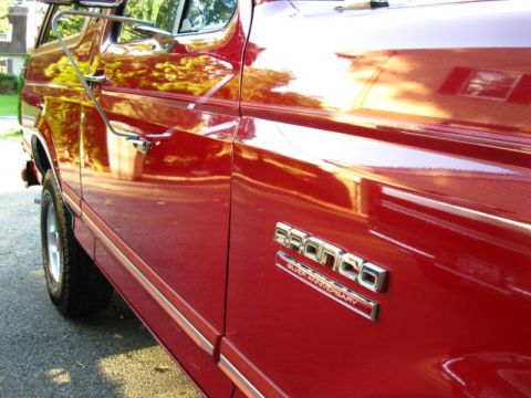 1994 Ford Bronco - Red 1994 Ford Bronco with 'Silver Anniversary' badging is shown from the side.