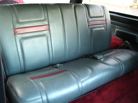 1994 Ford Bronco - Interior view of a gray leather rear bench seat with red accent stripes and visible seatbelts.
