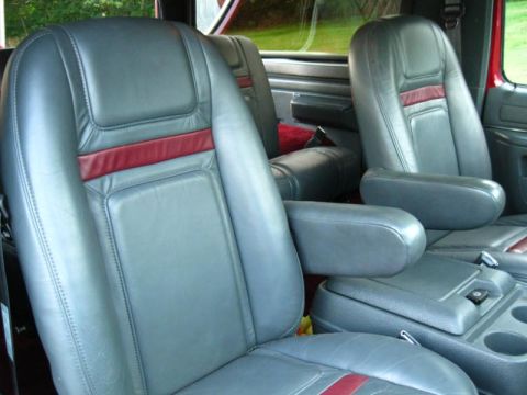1994 Ford Bronco - Interior view of a 1994 Ford Bronco, its gray leather seats with distinctive red accents and armrests.