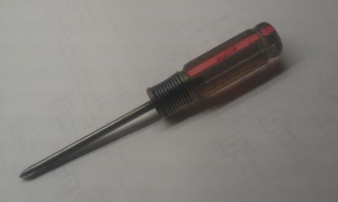 1965 Ford Mustang - A screwdriver rests on a document, with a SuperMotors watermark visible.