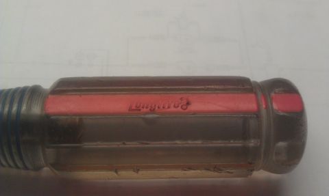 1965 Ford Mustang - Close-up of a screwdriver handle with a red insert displaying the "Longlife" brand name.