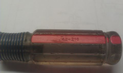 1965 Ford Mustang - A close-up view of a screwdriver handle with visible text.