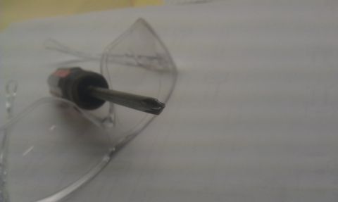 1965 Ford Mustang - A screwdriver is positioned on a piece of clear plastic, with the Supermotors.net logo visible in the lower right corner.