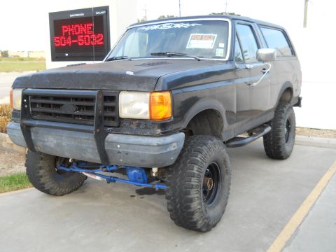 1992 Ford Bronco - This lifted 1992 Ford Bronco features off-road tires and a custom grille guard.