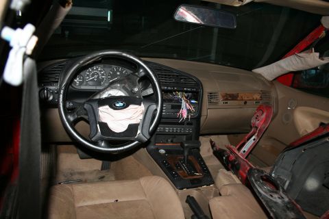 1996 BMW 3 Series - Interior view of a 1996 BMW 3 Series showing a deployed driver's side airbag and damage.