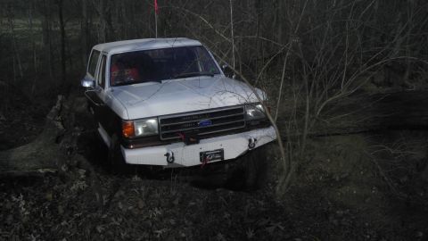 1989 Ford Bronco - This Ford Bronco is navigating a wooded trail with a custom front bumper.