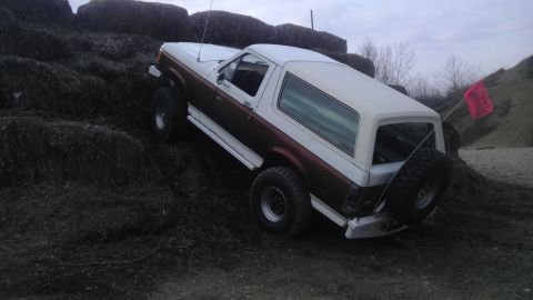 1989 Ford Bronco - This 1989 Ford Bronco is shown navigating an off-road course with a red flag attached to its rear.