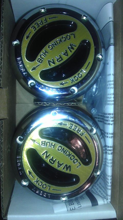 1989 Ford Bronco - Pair of Warn manual locking hubs, likely for a 4x4 vehicle, shown in their packaging.