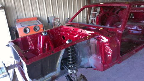 1970 Ford Mustang - The body of a 1970 Ford Mustang is shown in a workshop, stripped down for restoration work.