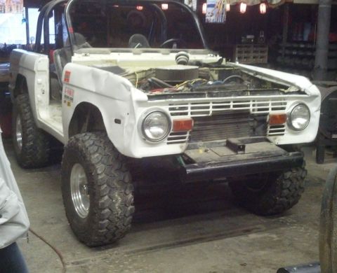 1970 Ford Bronco - This 1970 Ford Bronco is undergoing repairs with its hood open and interior exposed.