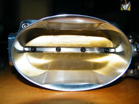2004 Ford Crown Victoria - Close-up view of an Accufab throttle body, showing the interior brass plate and mounting screws.