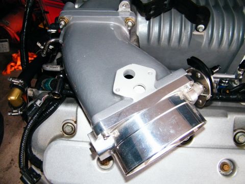 2004 Ford Crown Victoria - This is a close-up view of an engine's intake manifold, with a Supermotors.net watermark in the corner.