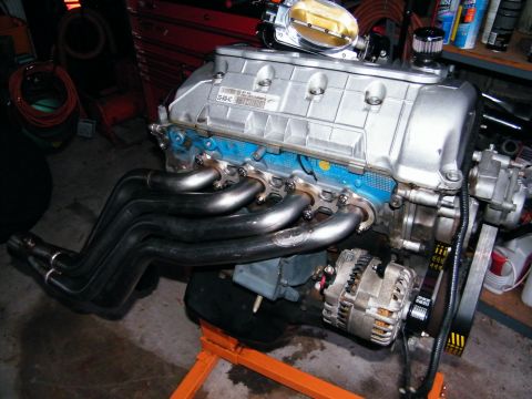 2004 Ford Crown Victoria - V8 engine assembly with custom headers and alternator, likely for a performance build.