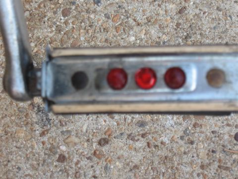 1994 Ford Bronco - A bicycle pedal with red reflectors is shown resting on a concrete surface.
