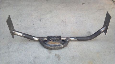 1978 Ford Bronco - This metal trailer hitch has two flat mounting plates and a central receiver tube, shown on a concrete surface.