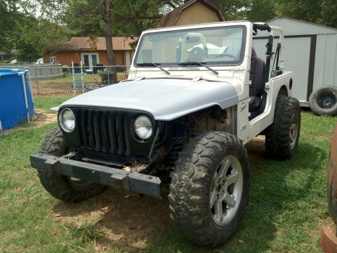 2000 Jeep TJ - This 2000 Jeep TJ is shown in a front 3/4 view, aftermarket wheels and tires.