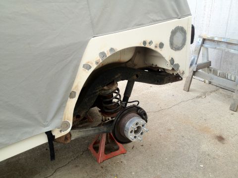 2000 Jeep TJ - This 2000 Jeep TJ shows body work on the rear fender, with the axle exposed on jack stands.
