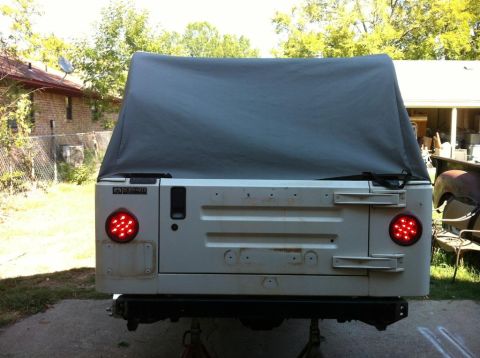 2000 Jeep TJ - Rear view of a white Jeep TJ with a soft top, showing its tailgate and taillights.